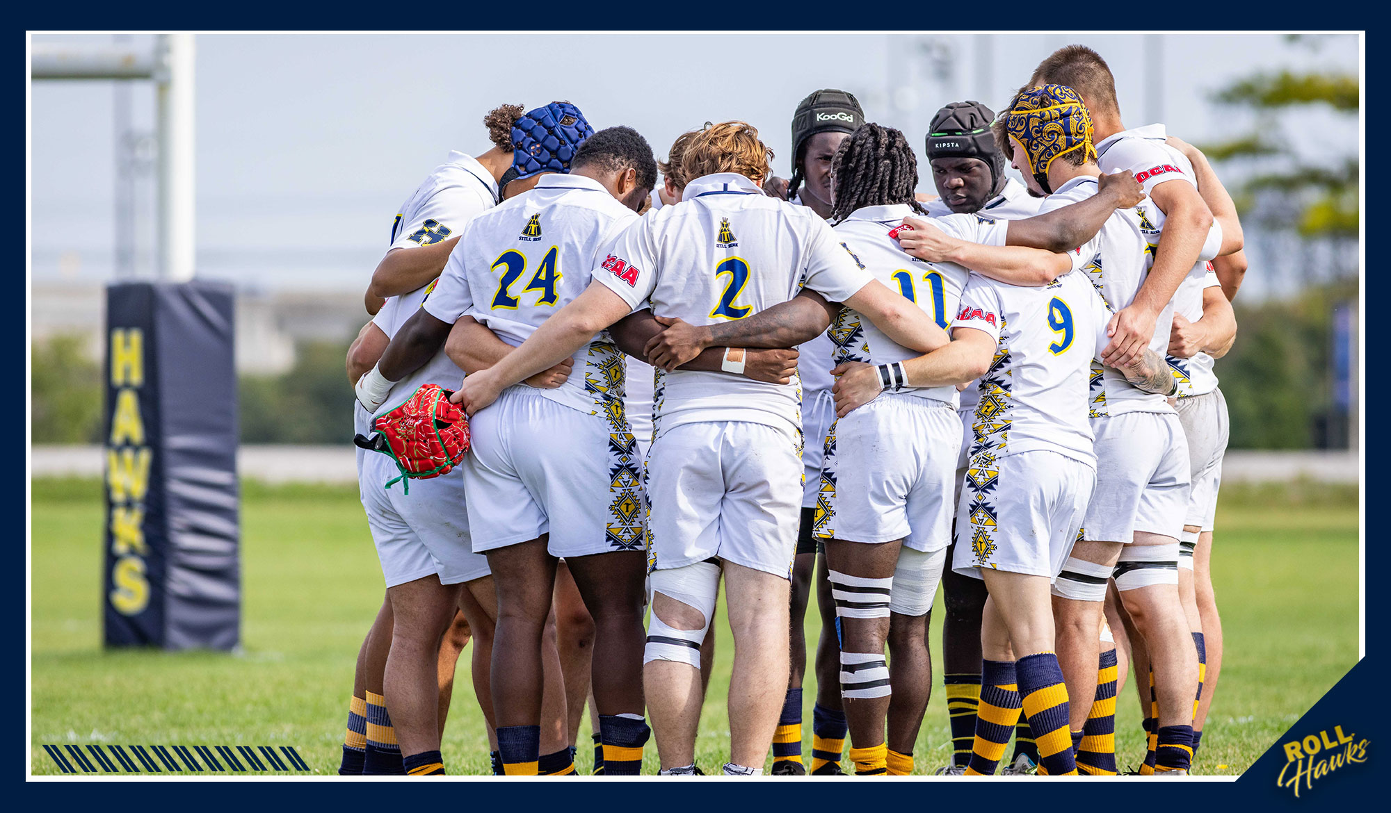 Men's rugby players huddled up
