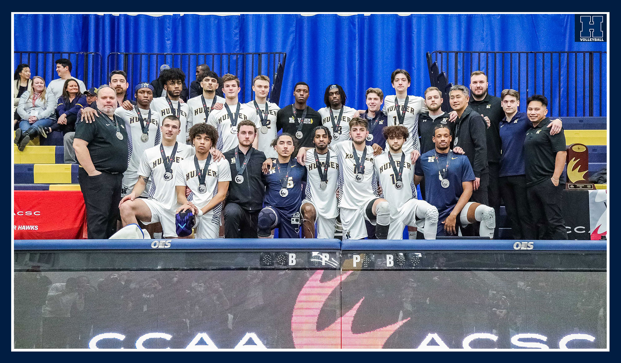 Men's volleyball team photo wearing their silver medals