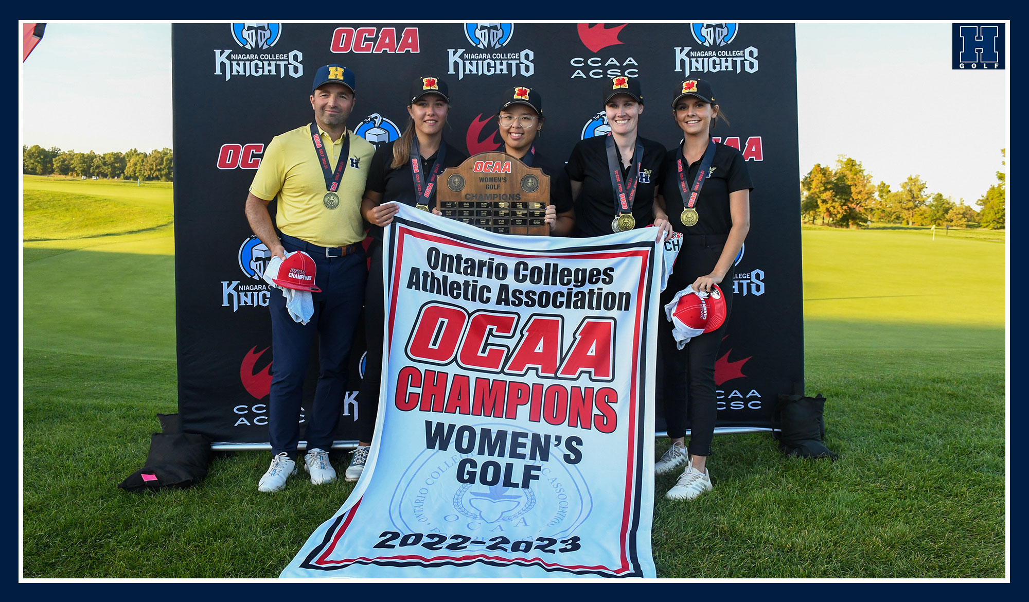 Women's golf team posing with their provincial banner