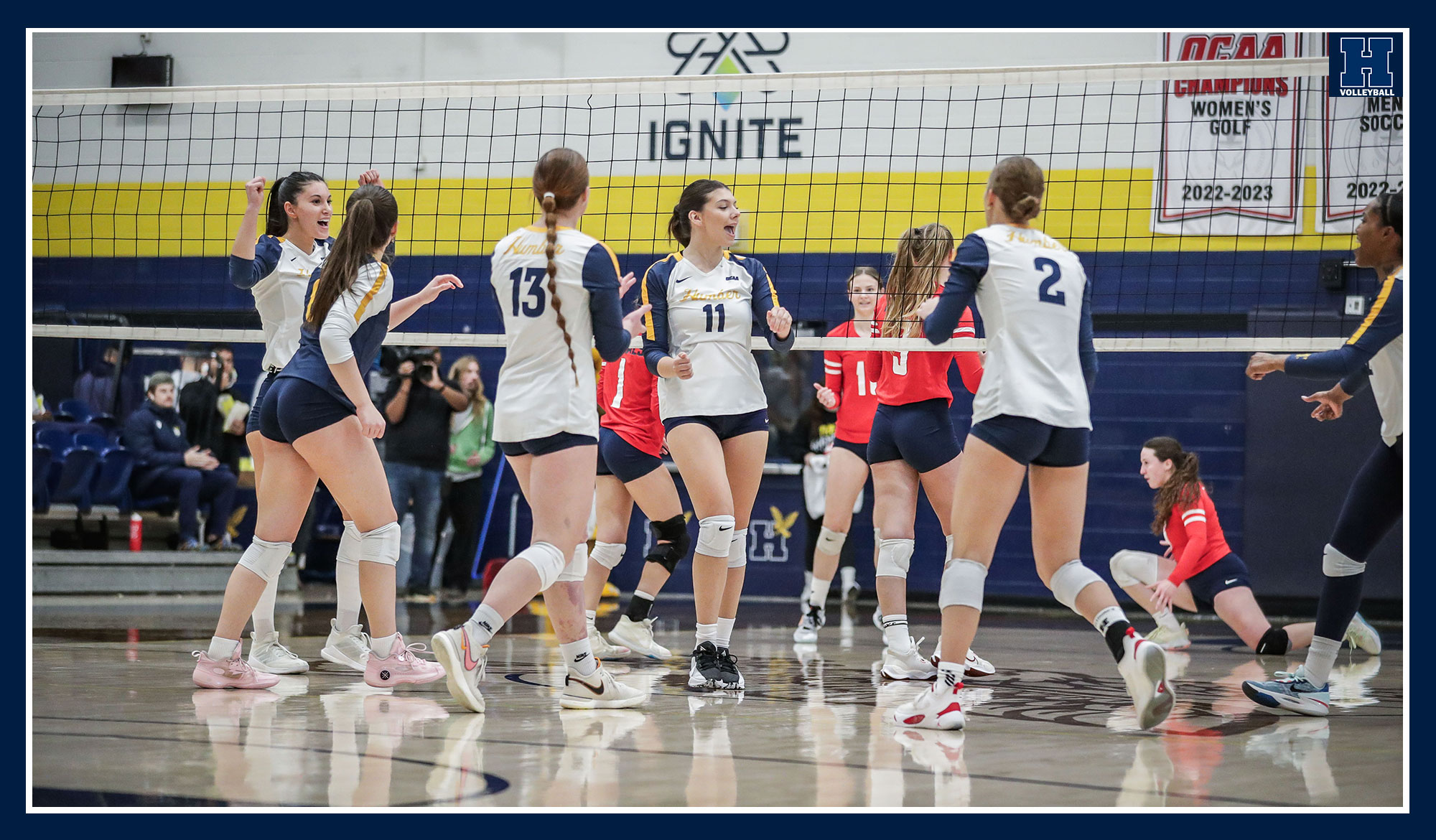 Women's volleyball celebrating a point