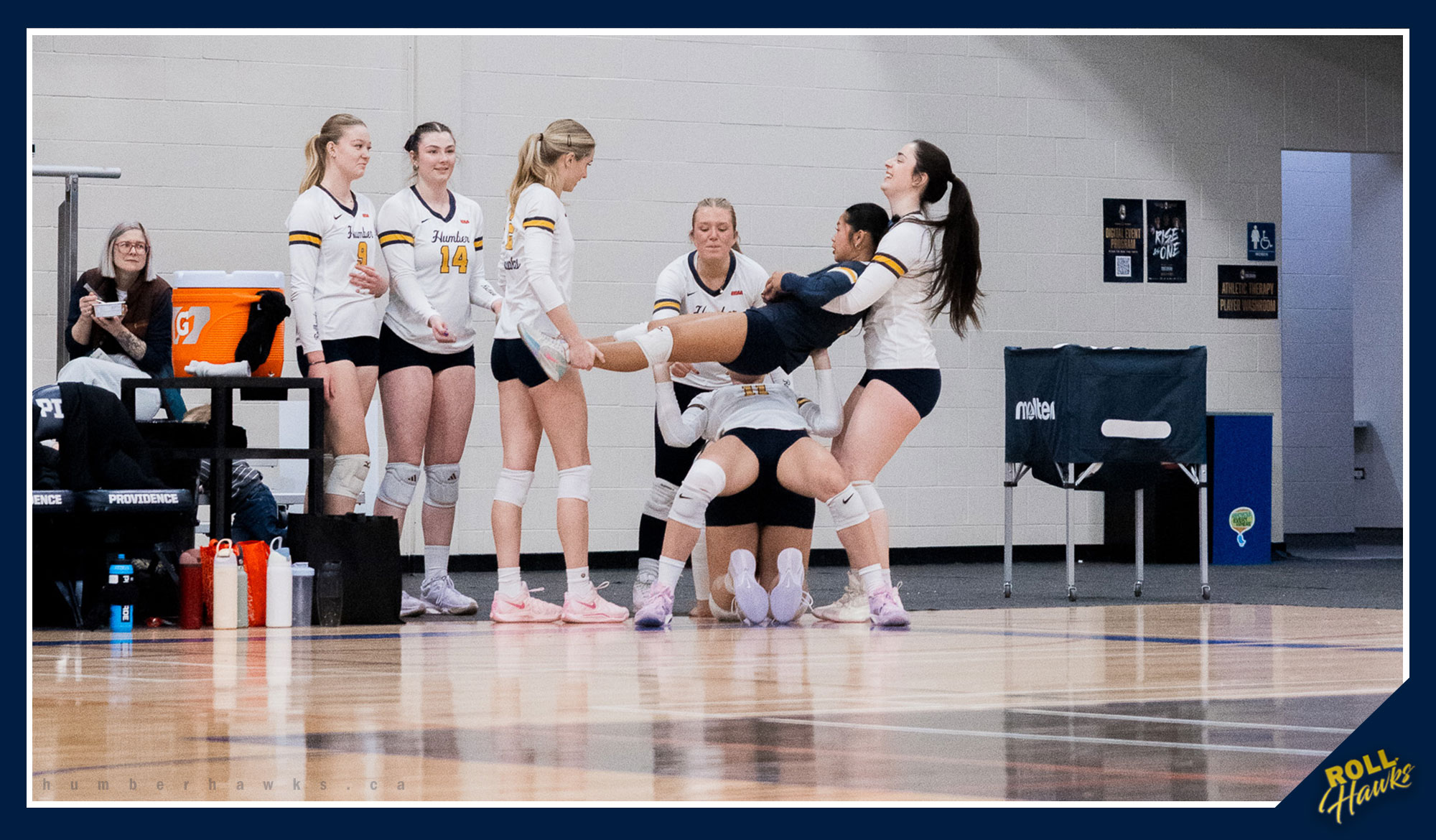 Women's volleyball bench celebrating